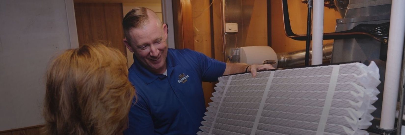 sunvena-hvac-resources-center SunVena HVAC technician showing a homeowner a pleated air filter