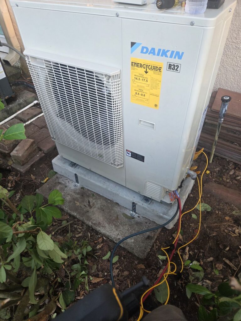 Daikin FIT heat pump outdoor unit installed beside a Lake Mary home